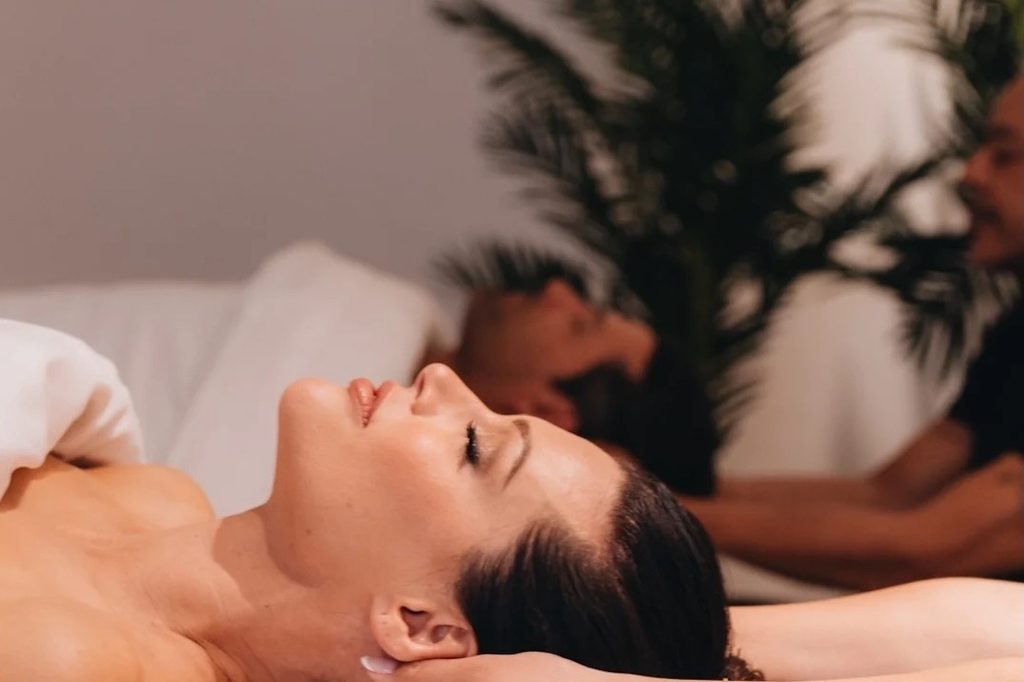 Couple lying side by side during a couples massage