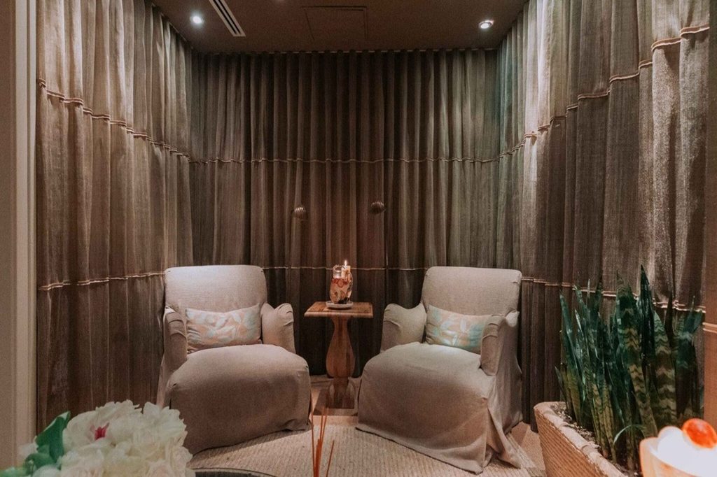 Spa relaxation lounge with armchairs and wood-slat walls