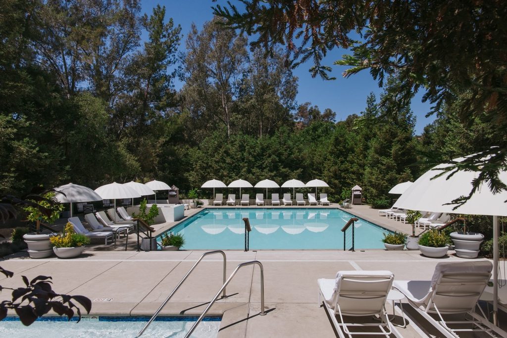 Tree-lined pool with umbrellas at Calamigos Ranch Resort & Spa in Malibu