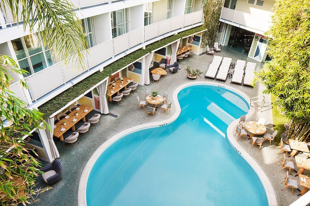 Curved pool and poolside cabanas at Avalon Beverly Hills