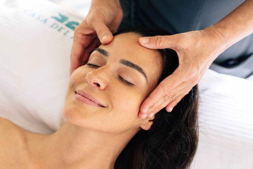 Woman receiving a facial massage at a spa