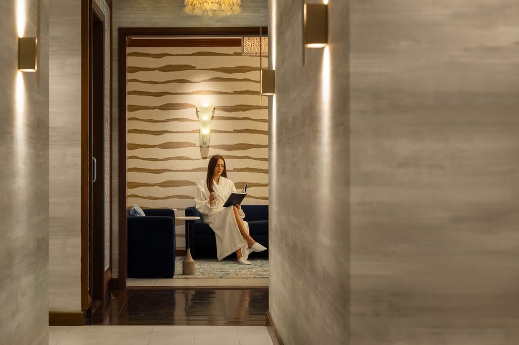 Guest reading in a hotel spa relaxation lounge