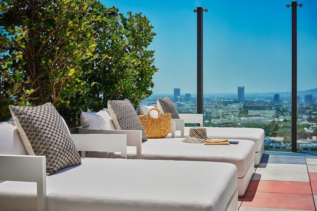 Poolside daybeds with views of the Los Angeles skyline